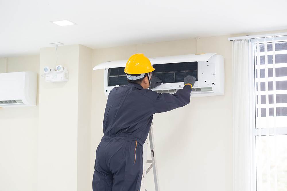 Residential HVAC maintenance being performed by a technician